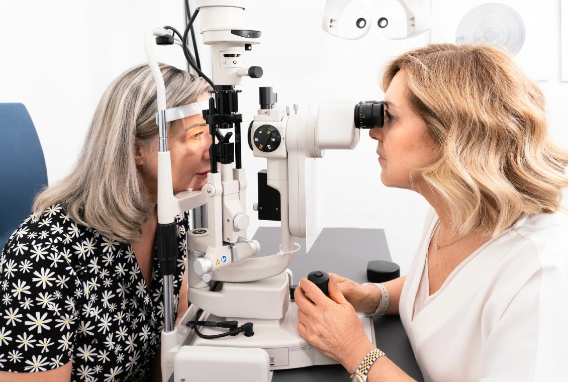 Eye examination with slit lamp machine.
