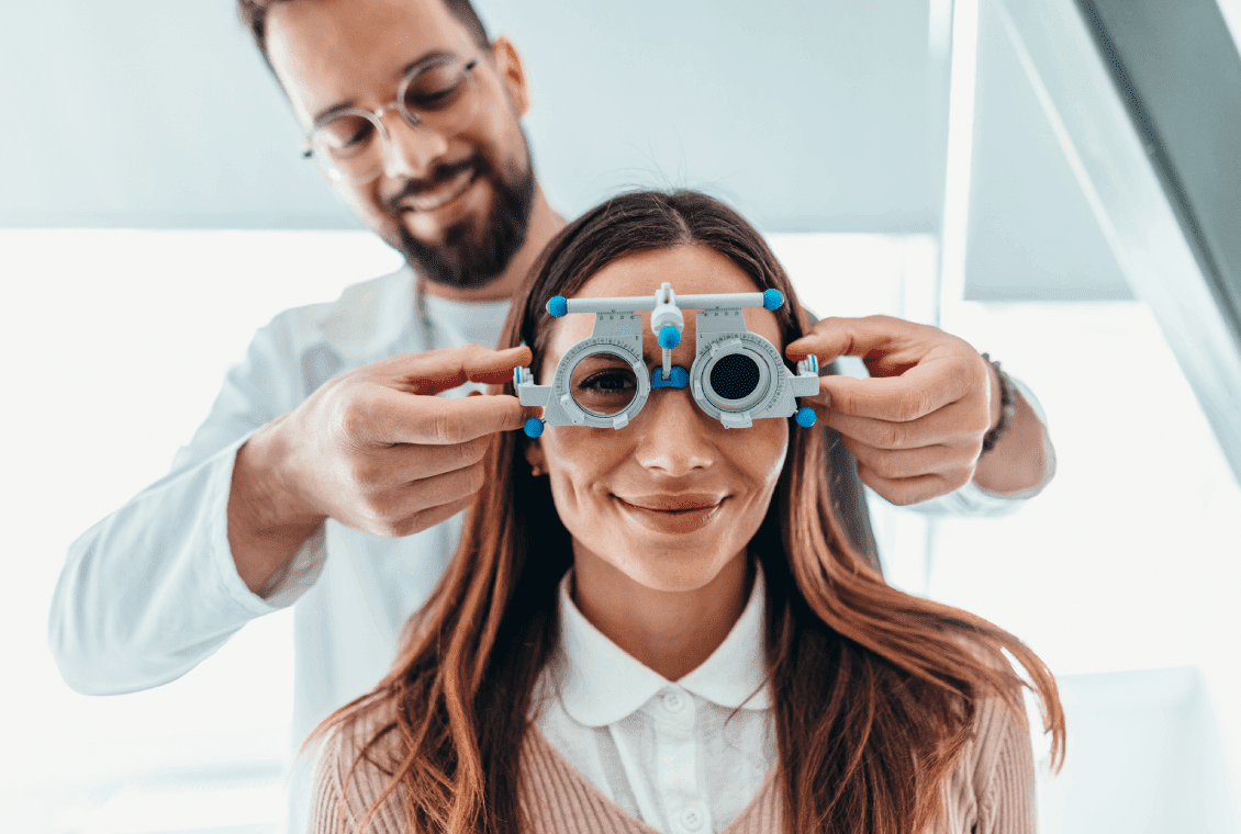 Optometrist adjusting trial frame on patient.