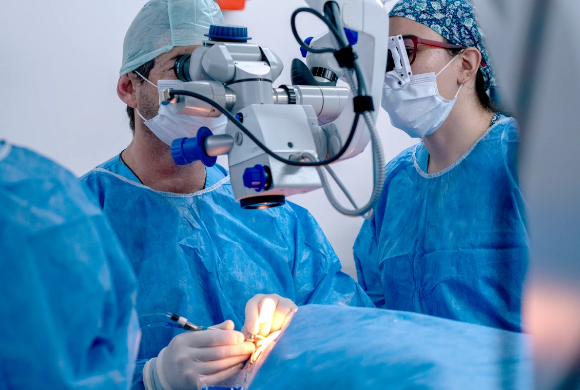 Surgeons performing surgery with advanced equipment.