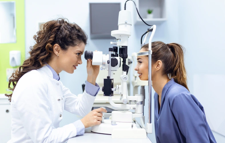 Eye examination with slit lamp in clinic.