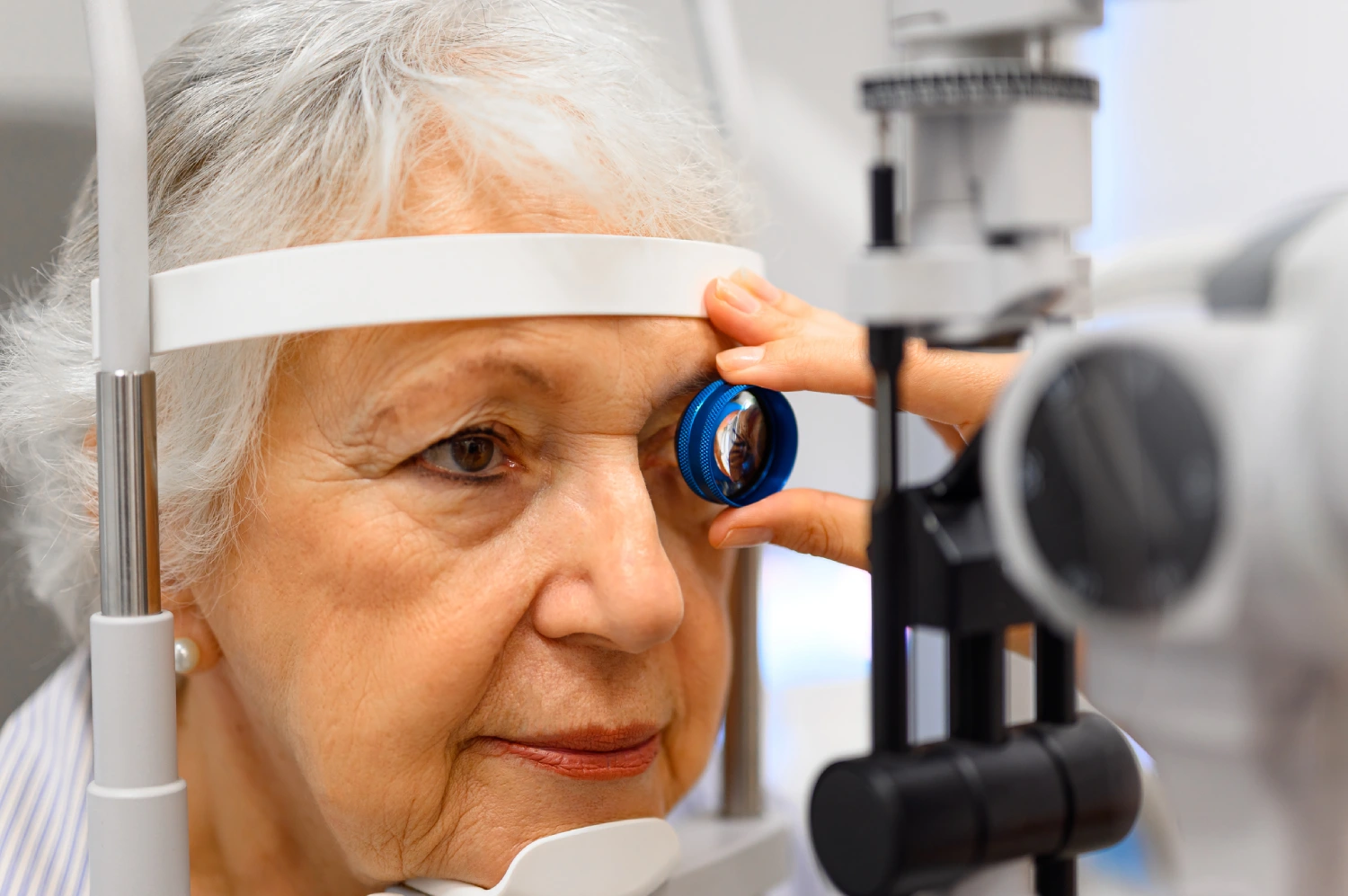 Senior woman undergoing eye examination procedure.