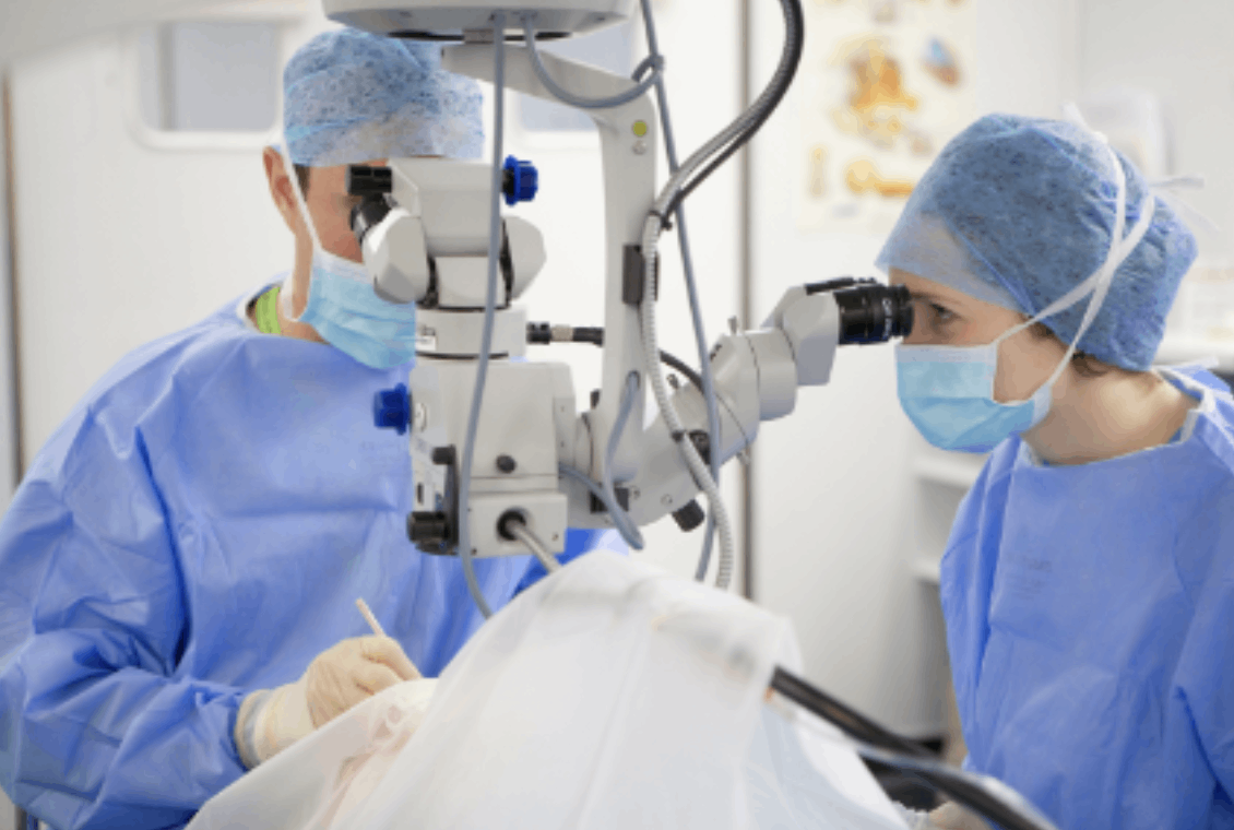 Surgeons performing surgery with advanced equipment.